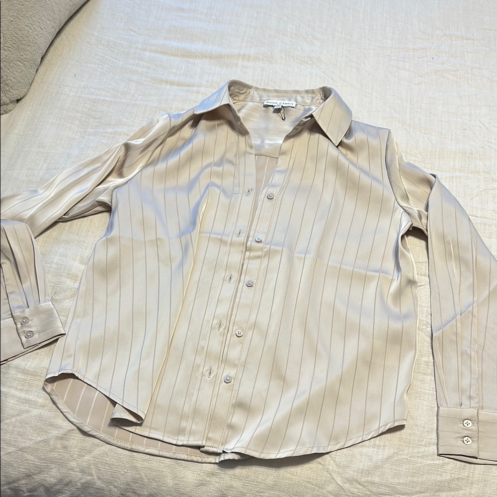 Cream long-sleeved button-up shirt with relaxed fit and collar